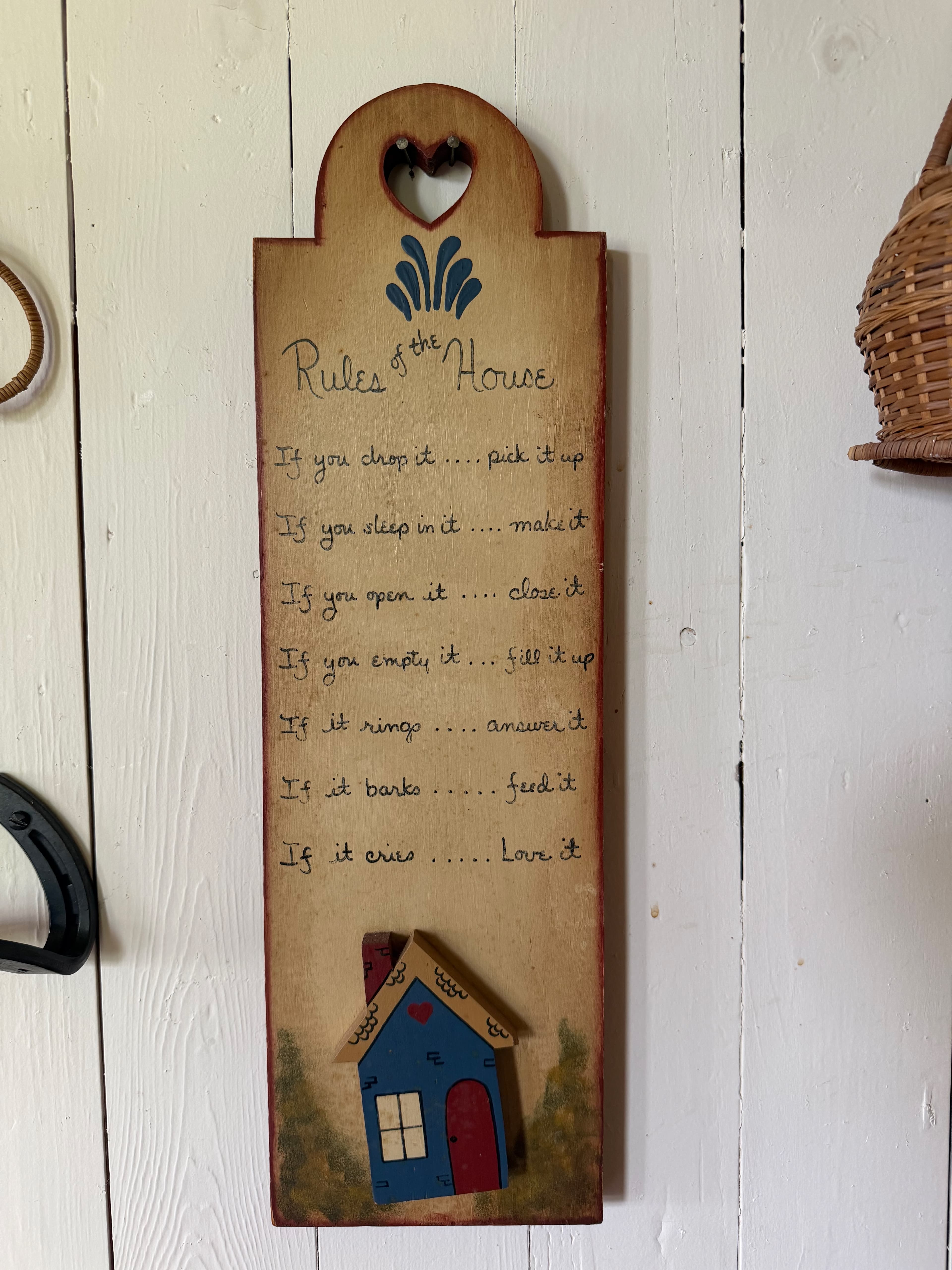 The hand-painted 'Rules of the House' plaque hanging at the Lodge